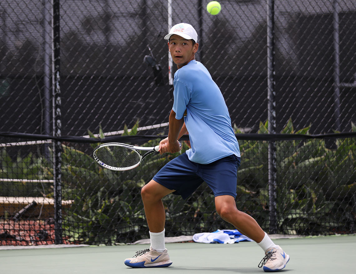 Boy in high school boys tennis rankings hits backhand during UTR Sports tennis match