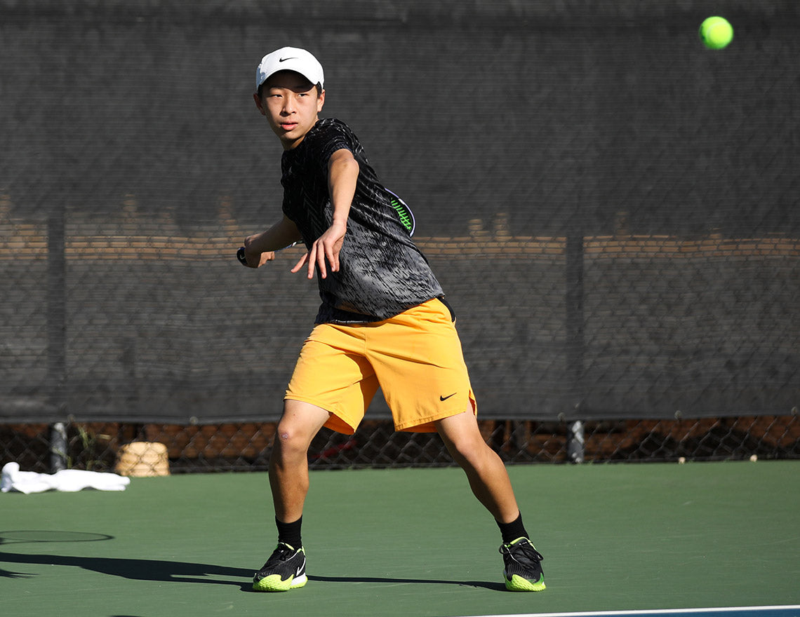 Boy prepares to hit a forehand while improving his u14 boys tennis ranking and his UTR Rating with UTR Sports