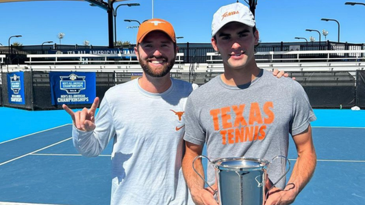 Young man holds trophy with coach