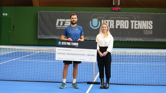 Petr Michnev poses with his prize money check at the UTR Pro Tennis Tour event in the Czech Republic.