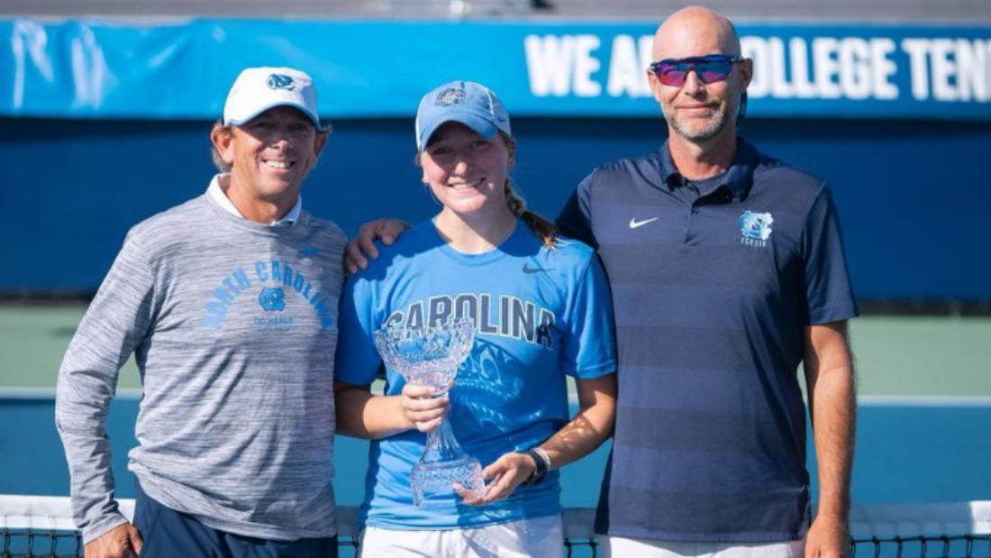 Reese Brantmeier posts with her ITA Fall National Championship trophy next to her coaches.  