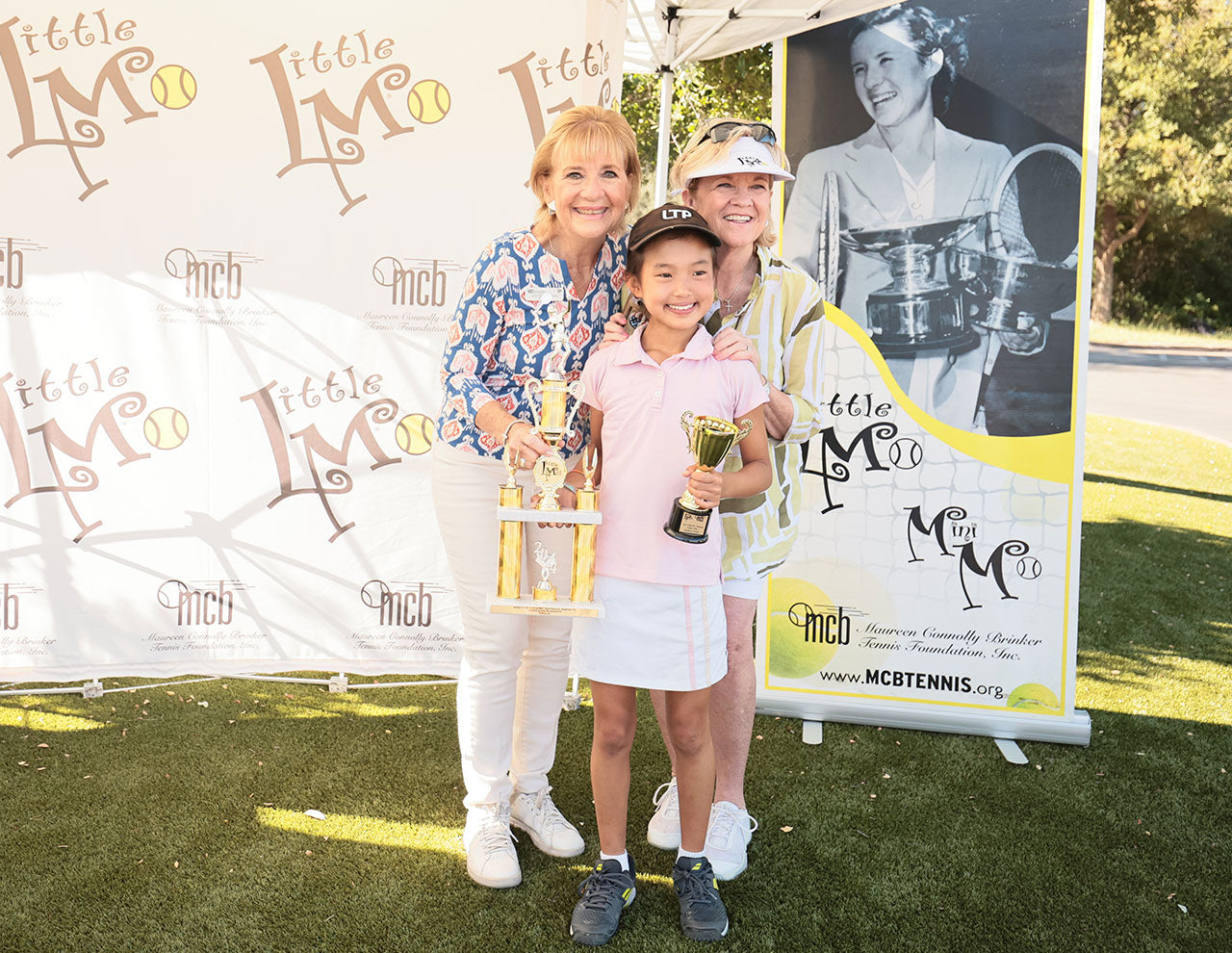 Girl smiles with Little Mo trophy 